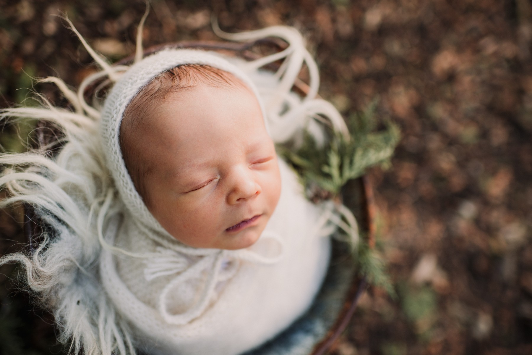 After: Newborn resting in a soft outdoor nest.