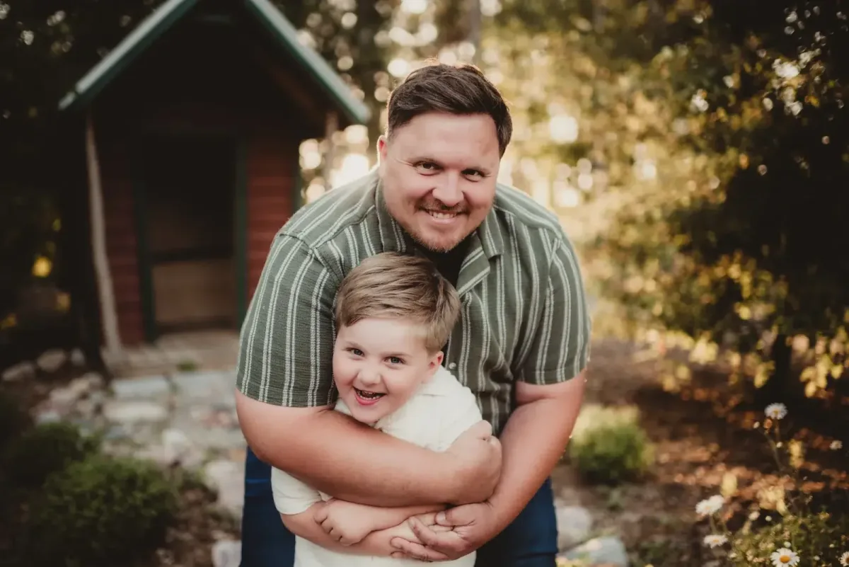 A father hugging his smiling young son