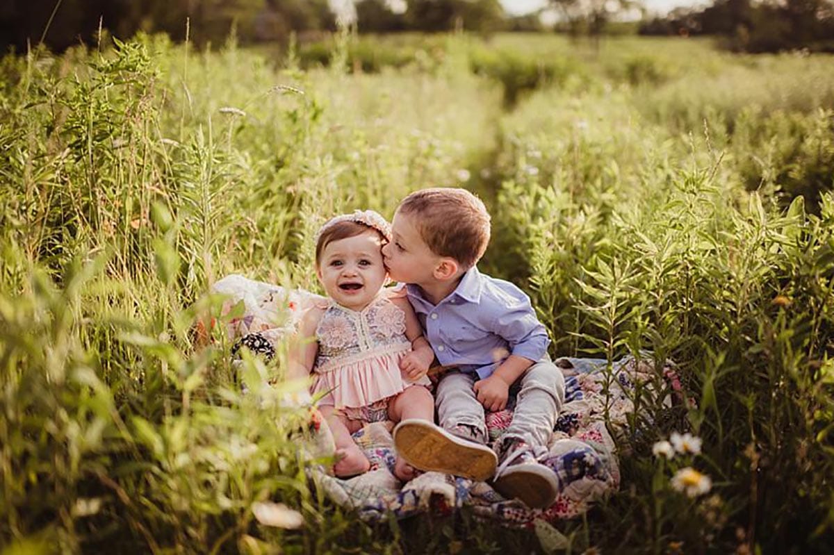 Brother Kissing Baby Sister on Cheek