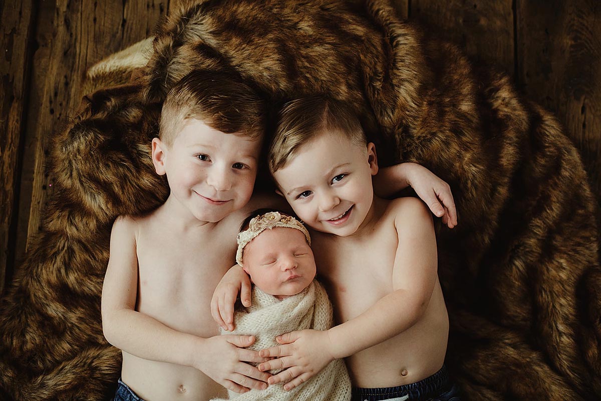 Brothers With Newborn Baby Sister