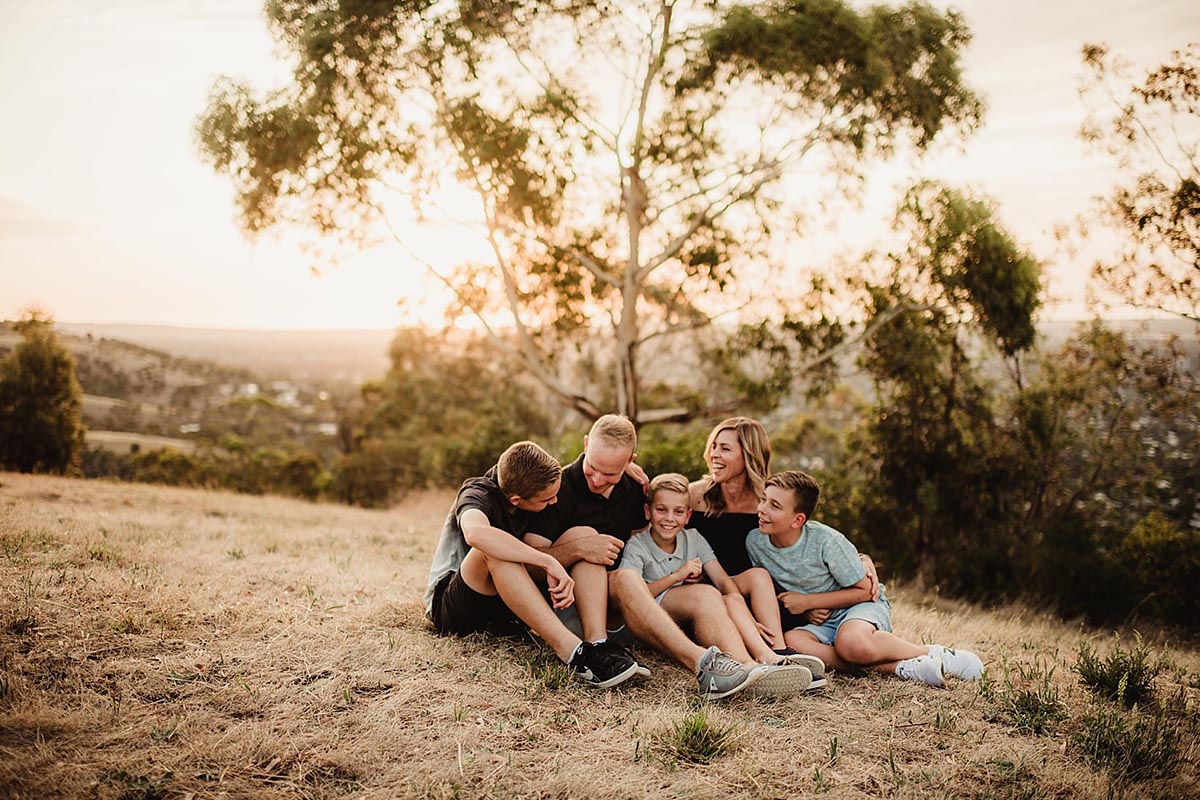 Family Sitting on Hill