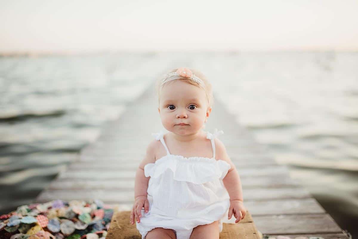 Baby Girl Sitting on Pier