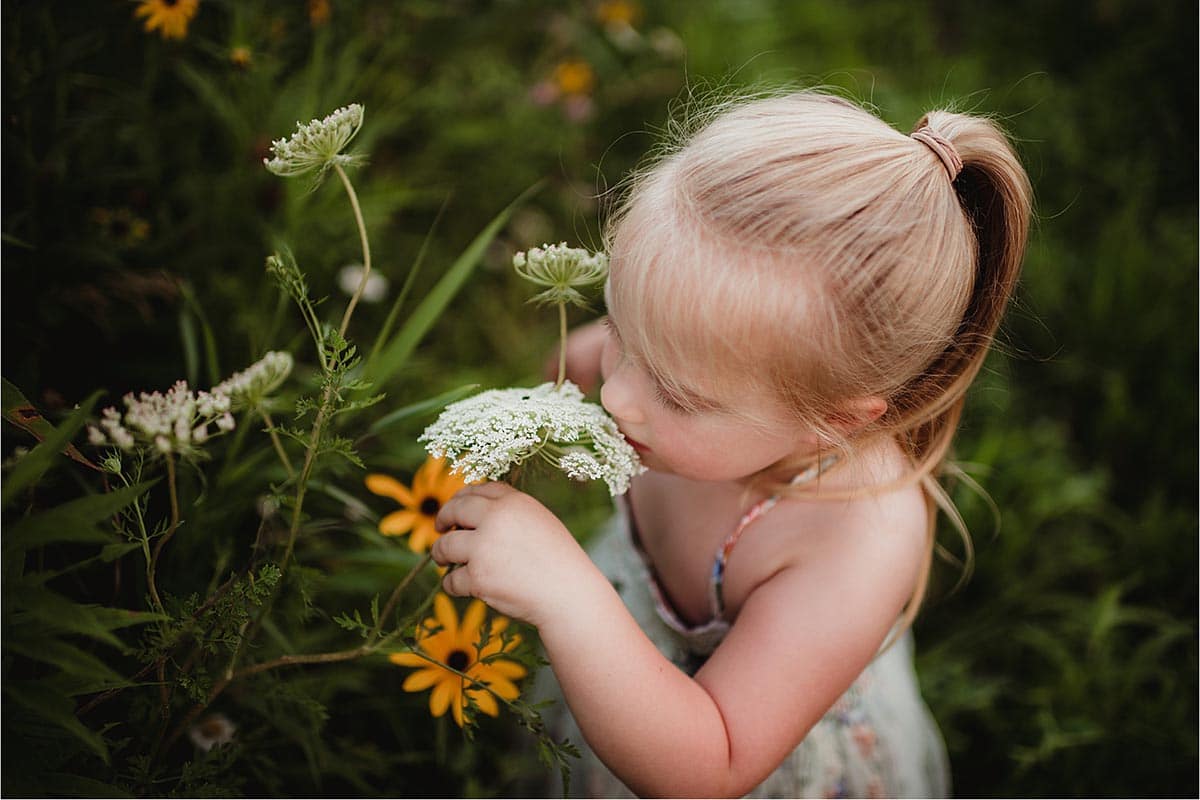 Little Girl Smelling Flower