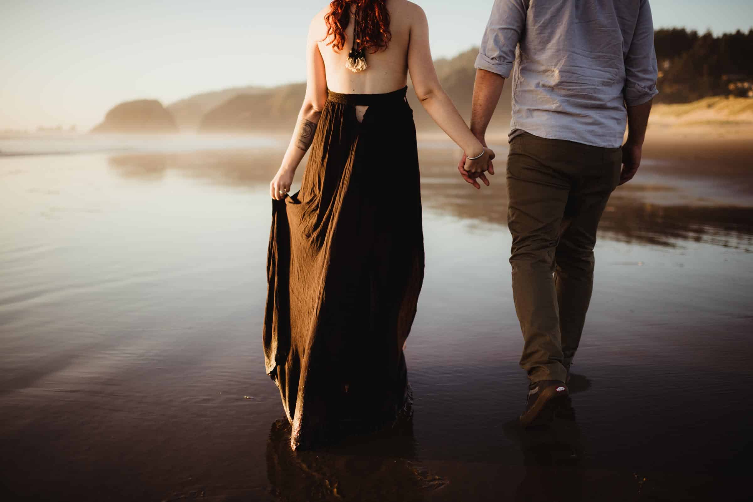 couple walking on the shallow shores in the Pacific Northwest