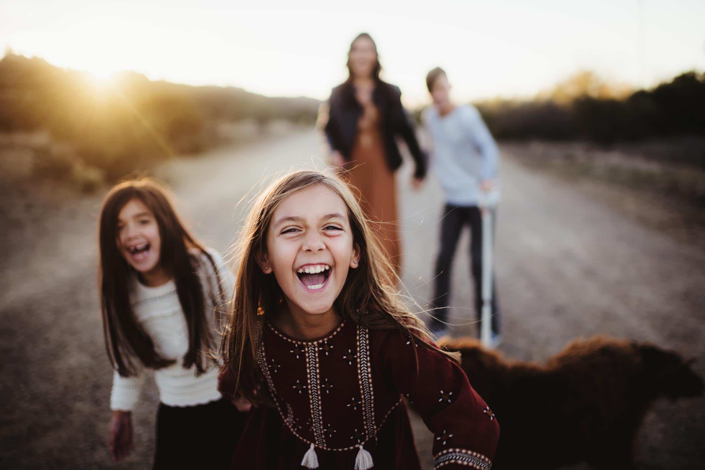 family playing in desert road