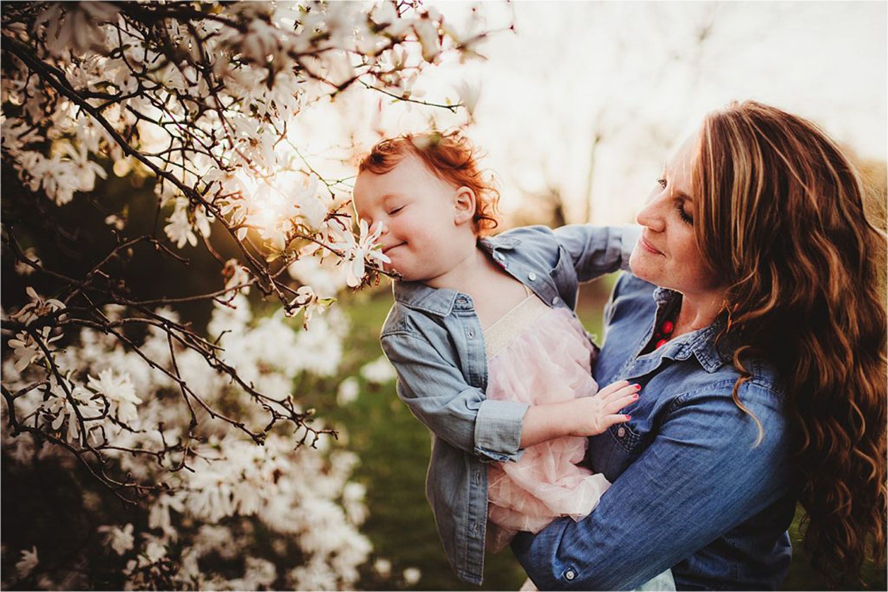 mom and daughter by spring blooms