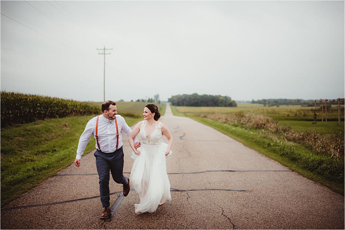 Bride and Groom Running on Road