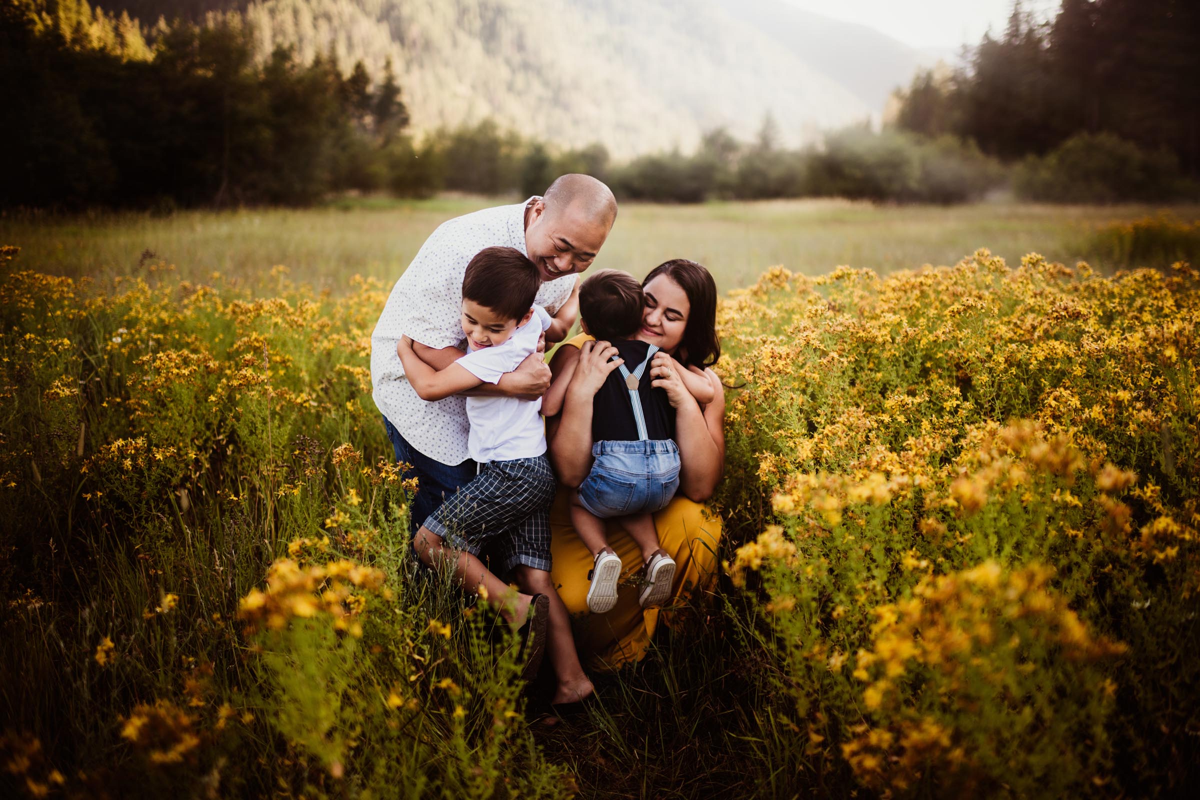 Parents Hugging Kids in Yellow Flower Field