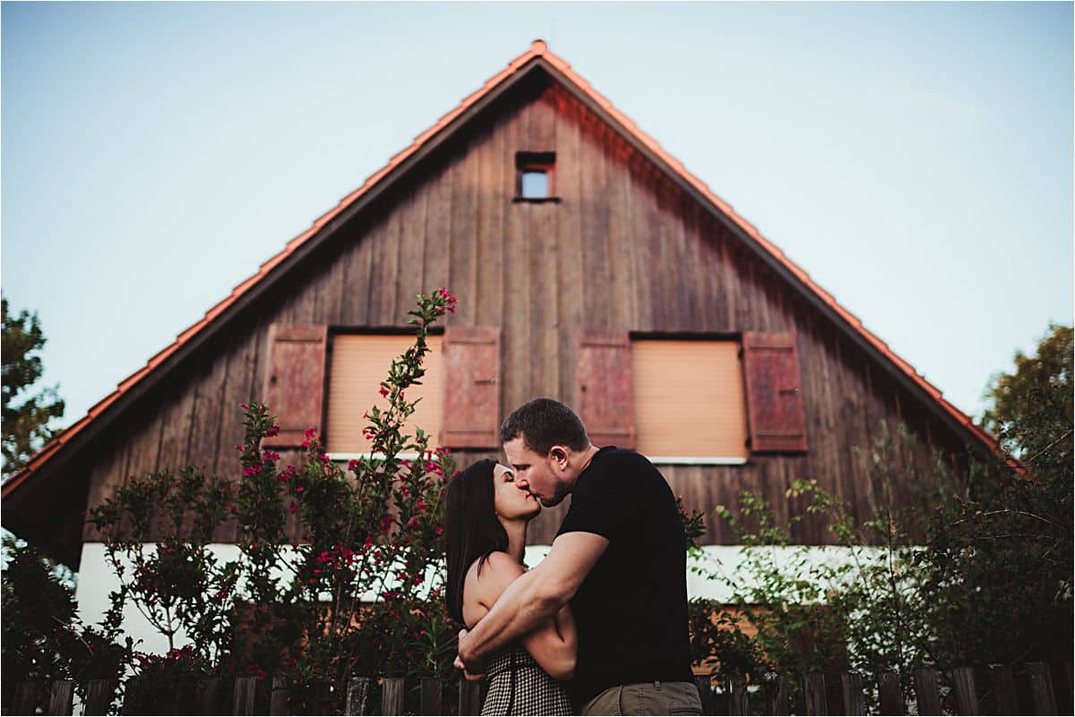 Couple Kissing in Front of Barn