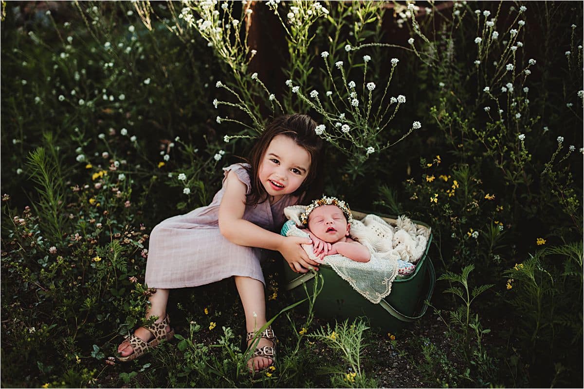 Urban Wildflower Newborn Session Big Sister with Newborn in Field