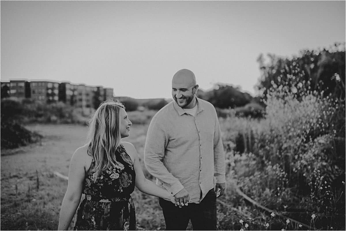 Urban Wildflower Engagement Session Couple Holding Hands Walking