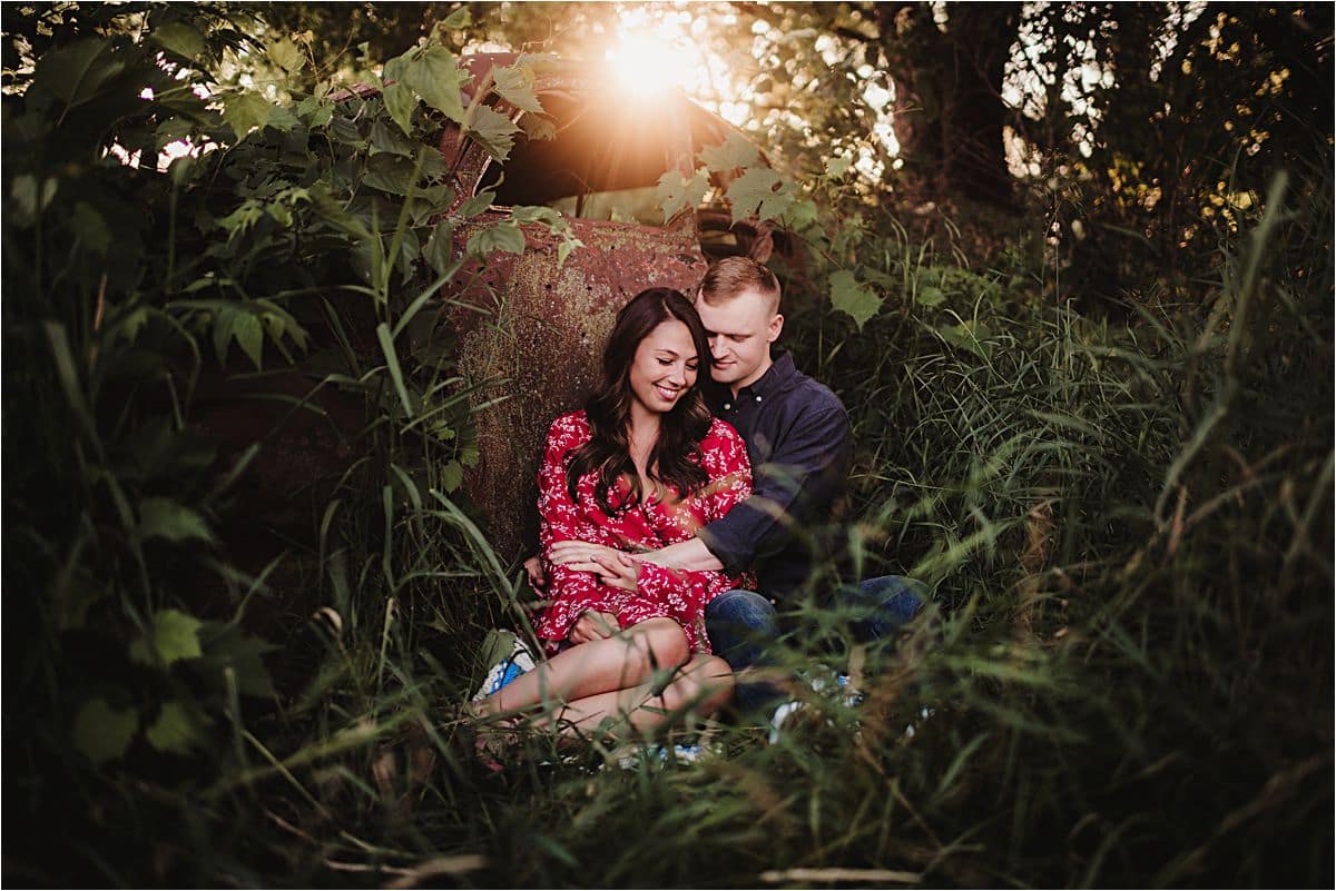 Romantic Sunset Engagement Session Couple Snuggling by Old Car