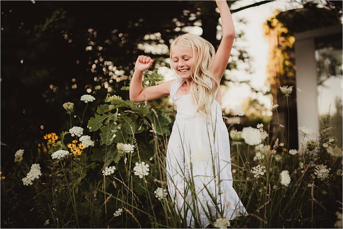 Playful Family Session Girl Jumping in Flowers
