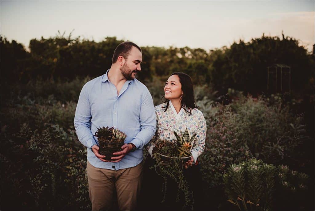 Couple Holding Plants