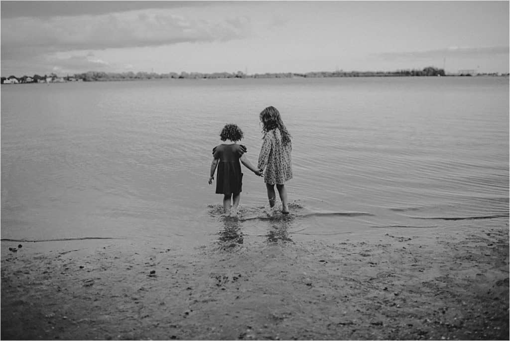 Sisters Holding Hands on Beach