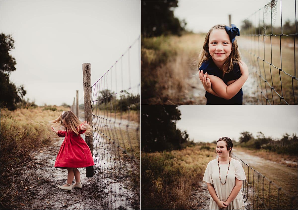 Three sisters pose along a wire fence on a dirt path during Split Oak Forest fall family photos