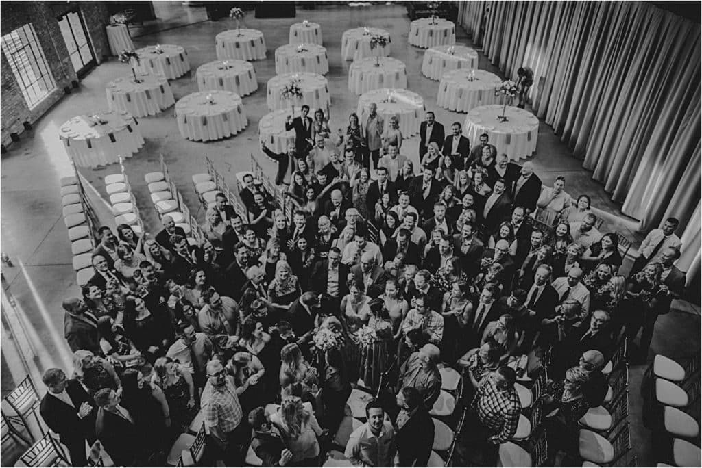 Romantic Industrial Summer Wedding Birdseye View Guests with Couple 