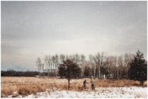 Winter Couples Session Couple Holding Hands in Field