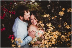 Late Spring Engagement Session Couple Snuggling in Flowers