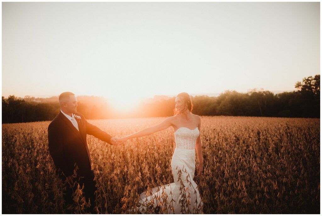 Bride Groom Holding Hands in Field