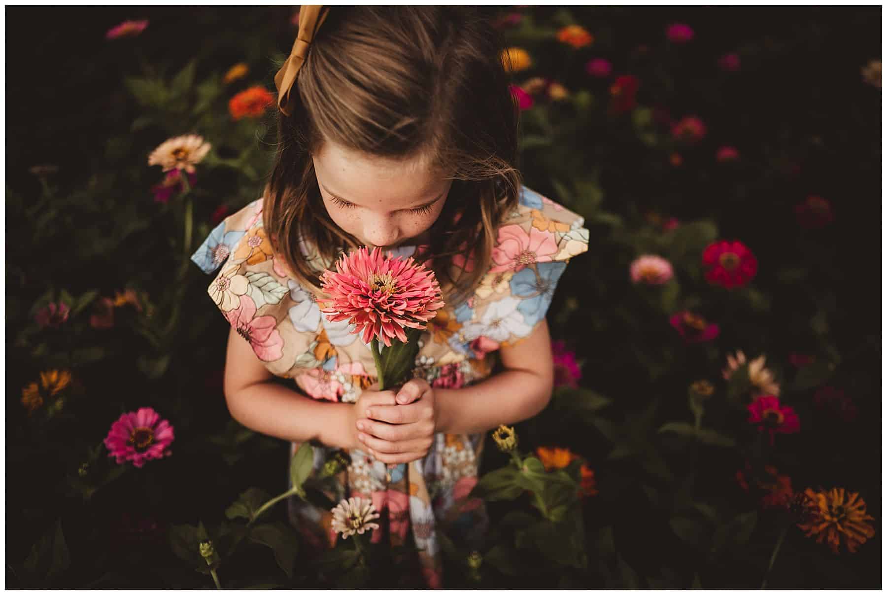 Little Girl Smelling Flower