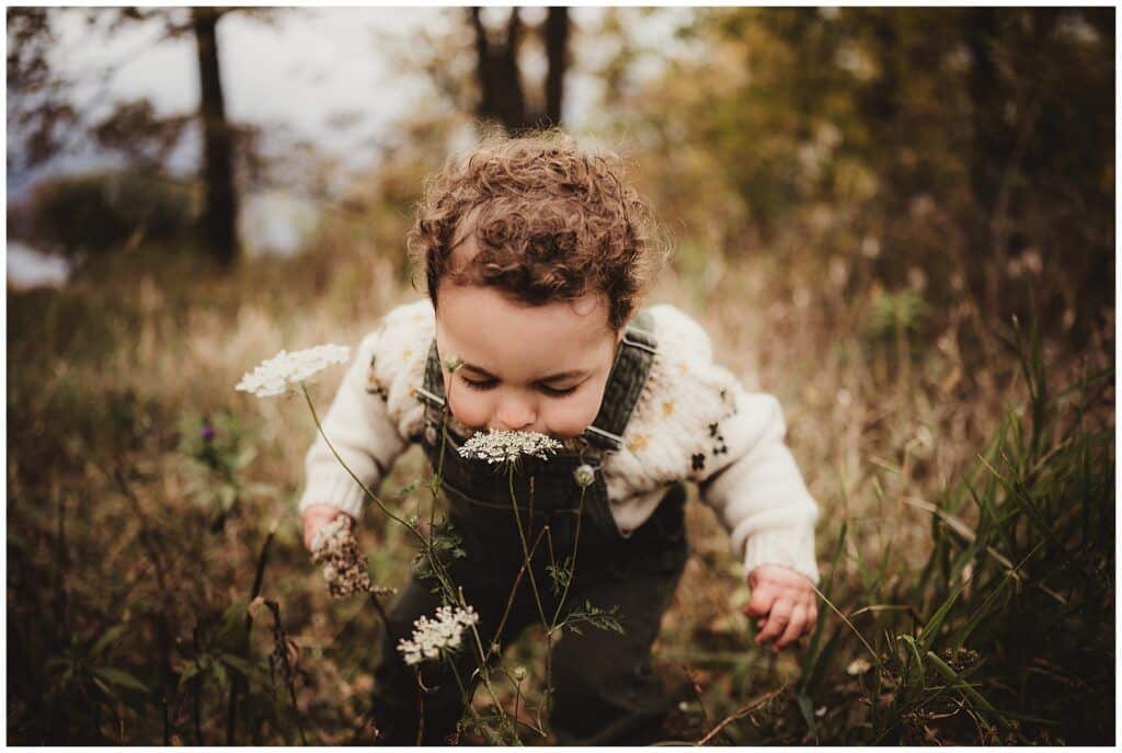 Little Boy Smelling Flower