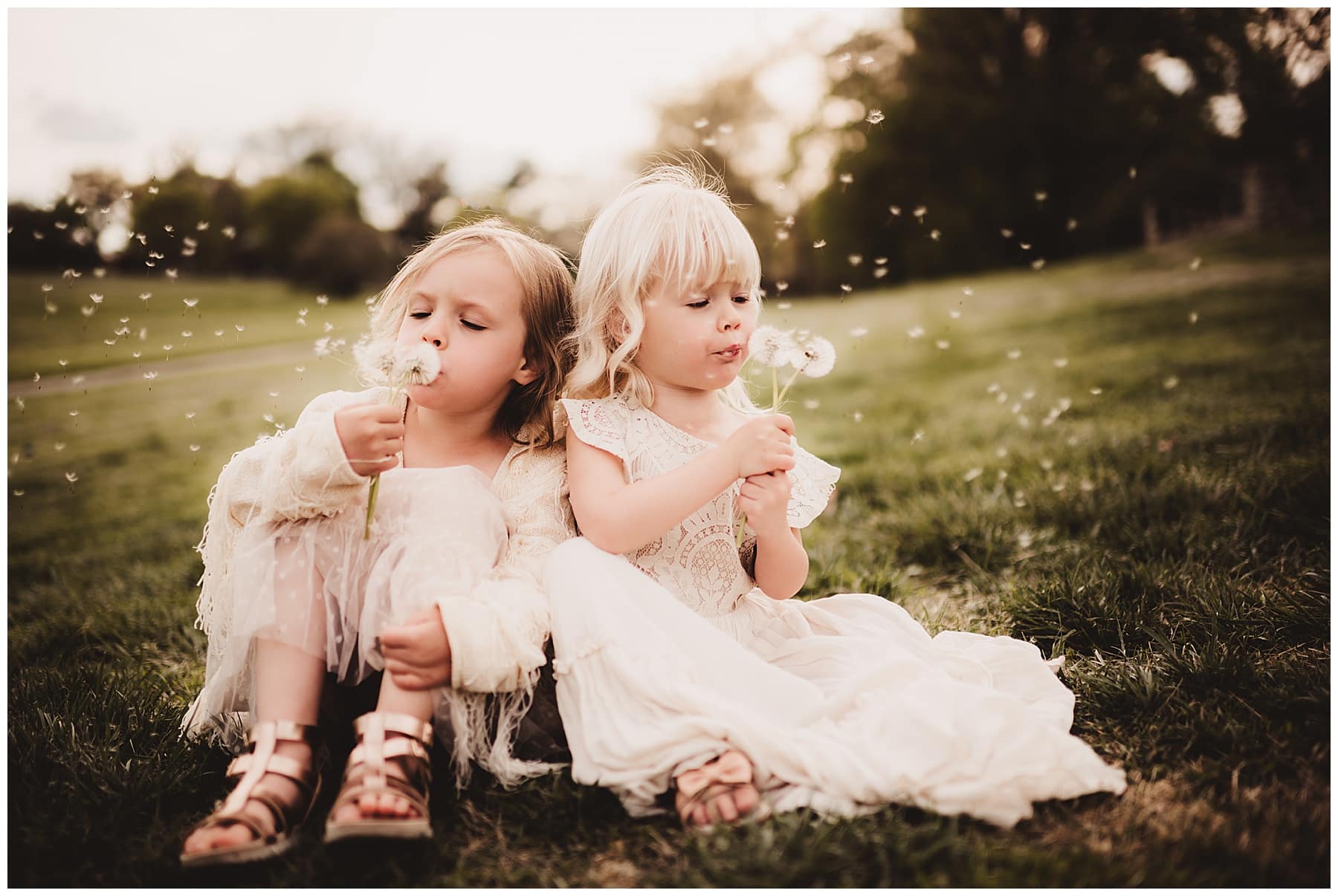 Little Girls Blowing Dandelions