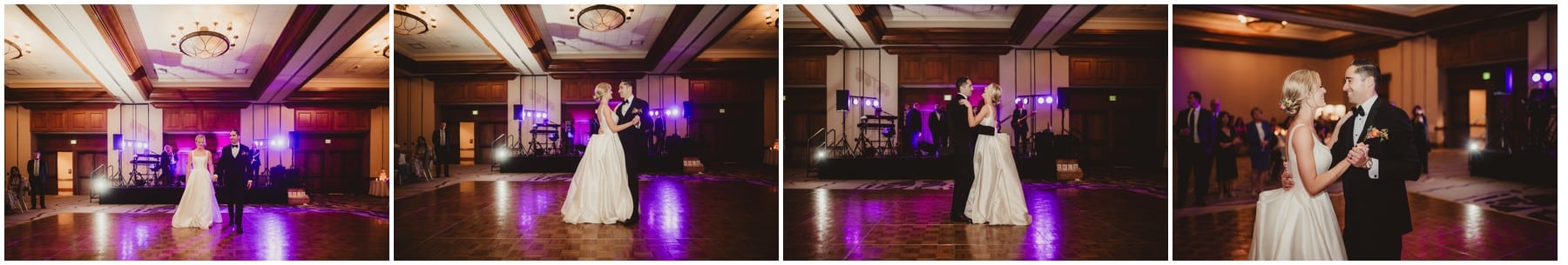 Newlyweds share their first dance on a warmly lit dance floor with a live band playing.