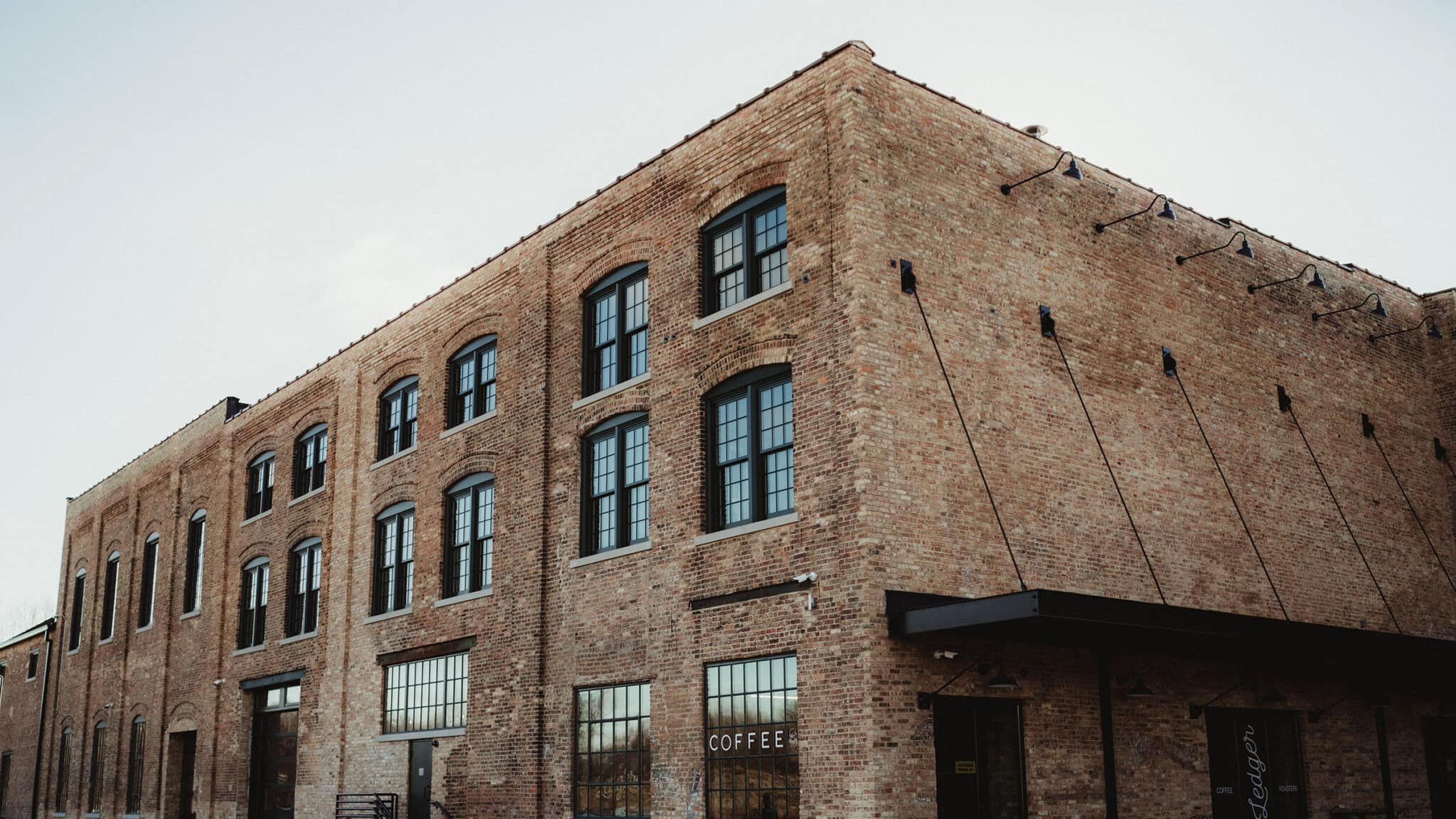 Exterior of a historic brick building with large windows, suitable for photography sessions in Madison, Wisconsin.