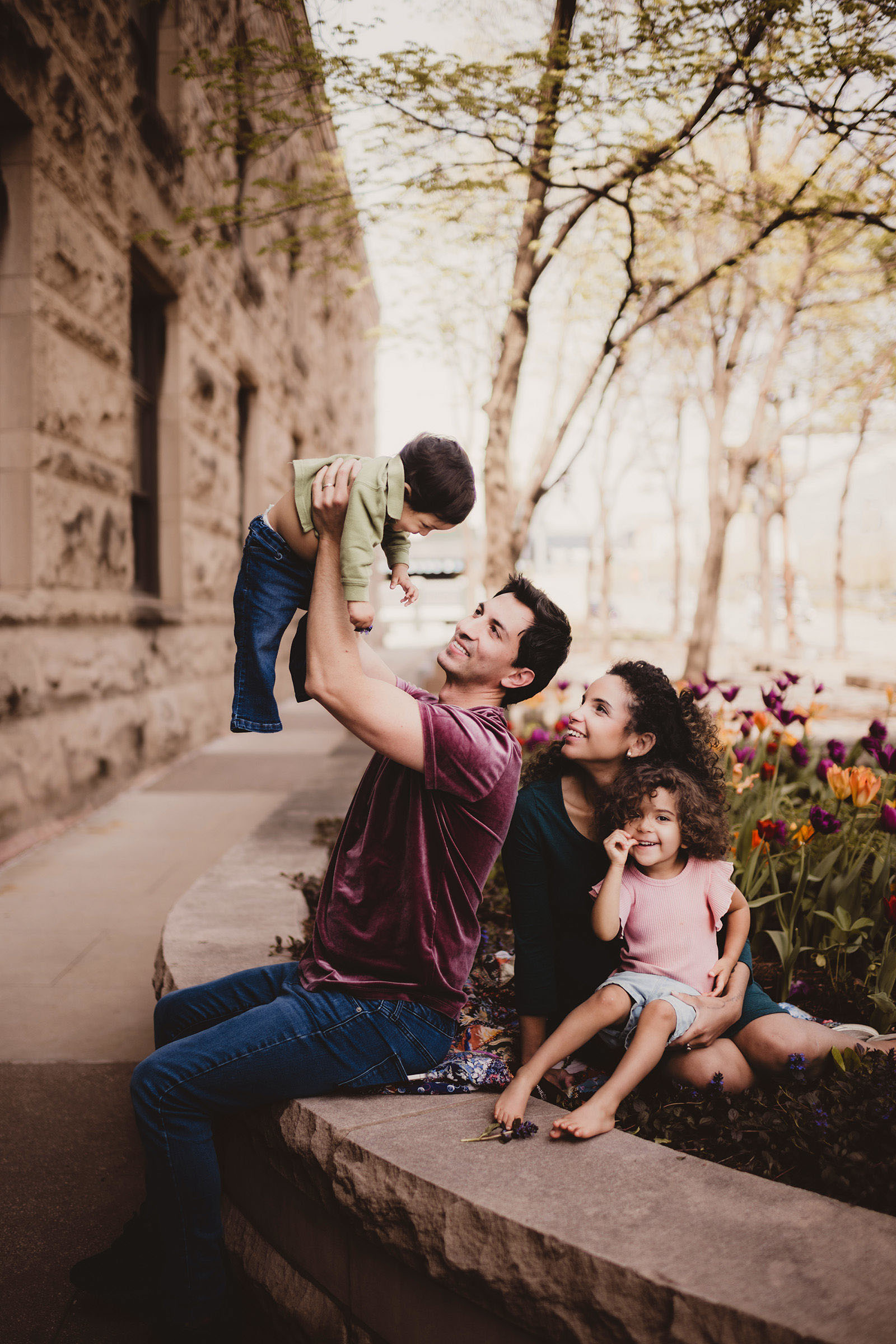 Family portrait surrounded by tulips in downtown Madison