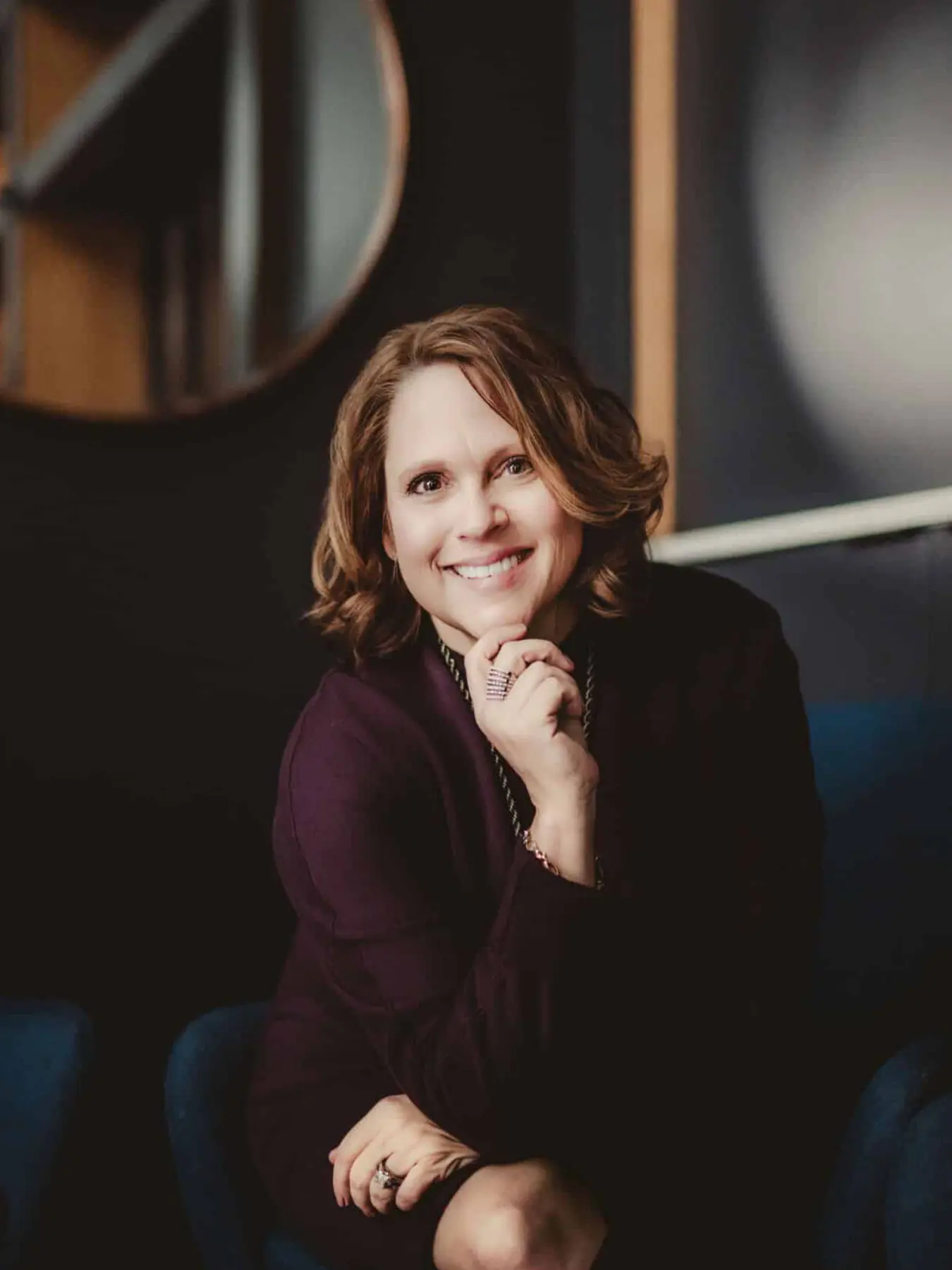 Warm and engaging professional branding portrait of a woman smiling captured by Twig and Olive Photography in Madison Wisconsin