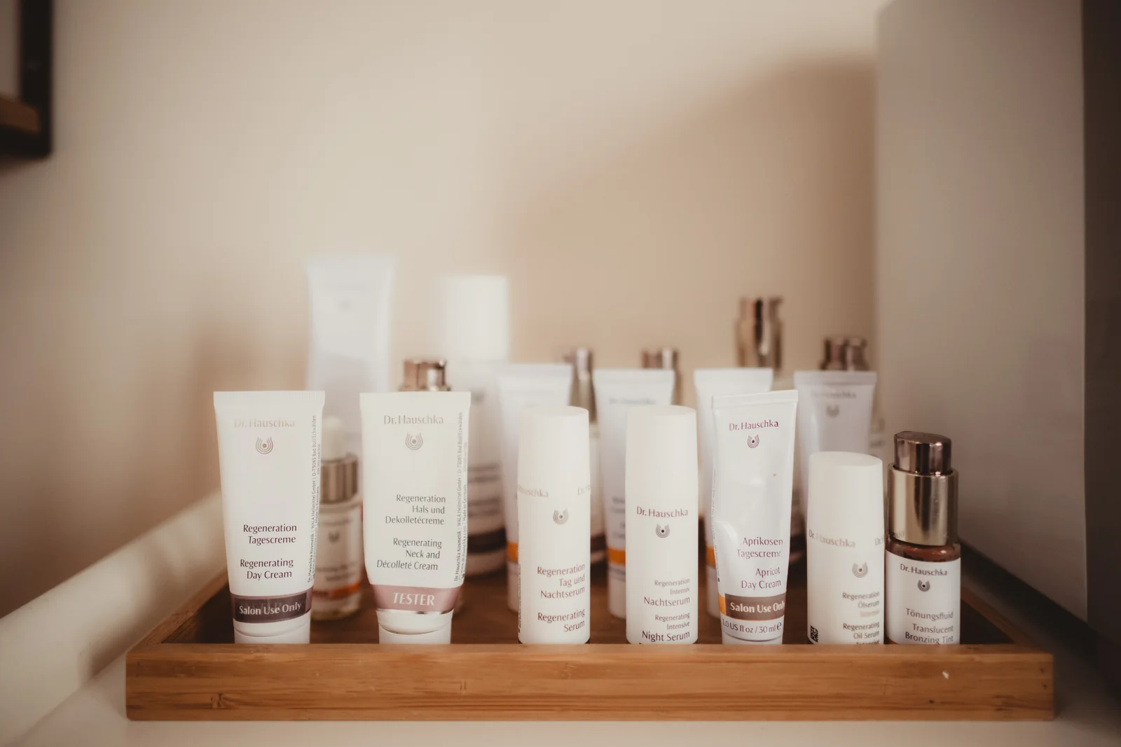 Skincare products arranged on a wooden display shelf.