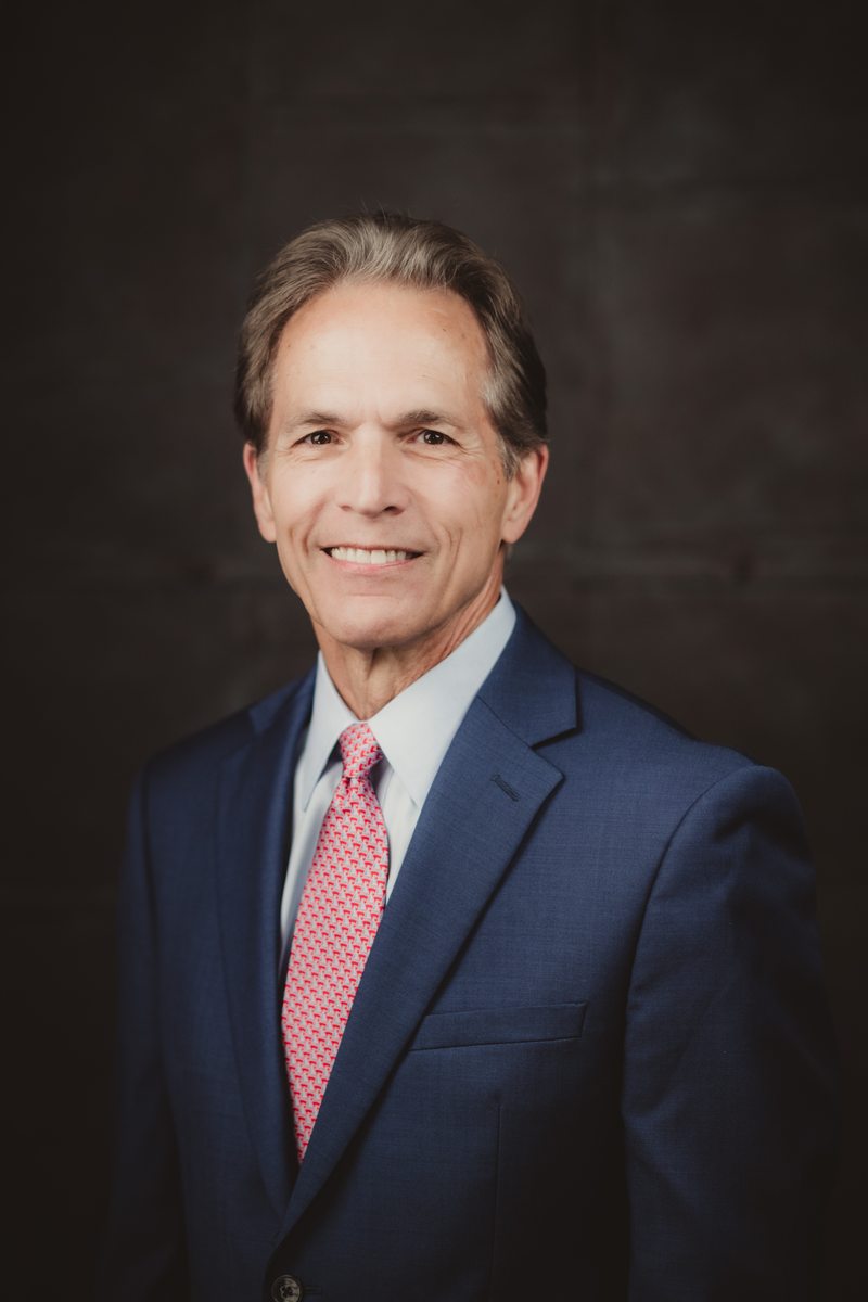 Custom headshot with a charcoal backdrop Portrait in a suit and tie against a textured charcoal backdrop