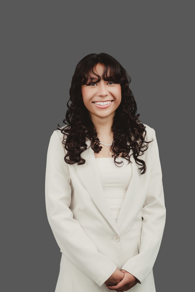 Custom headshot with a gray backdrop Portrait in a white outfit against a gray studio backdrop