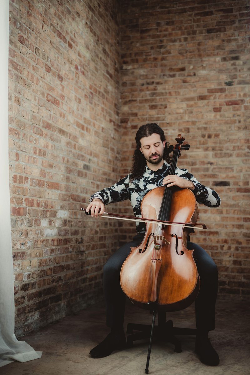 Musician portrait with a cello Musician with a cello in the brick studio