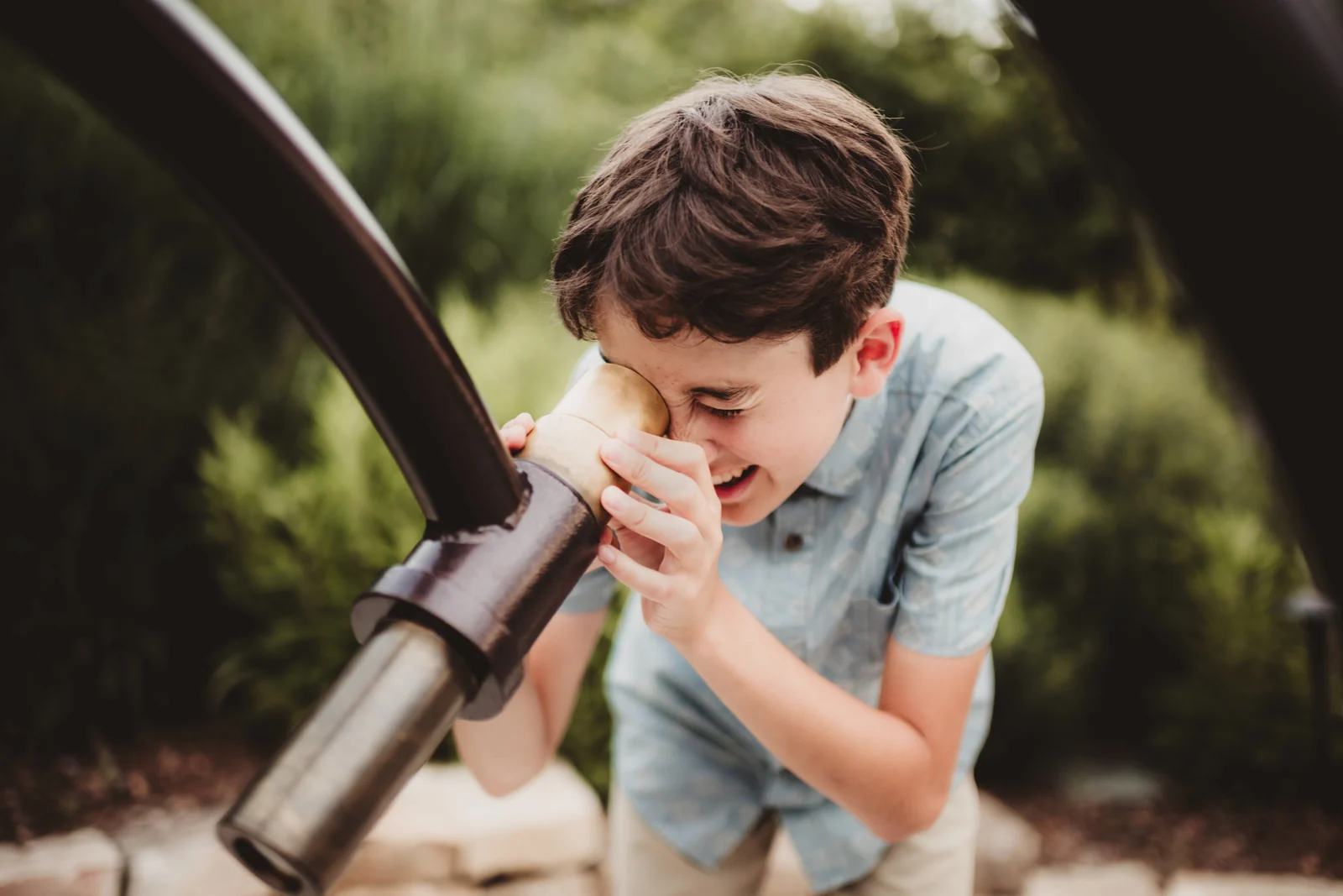 Child looking through a telescope A child looking through a telescope outdoors.