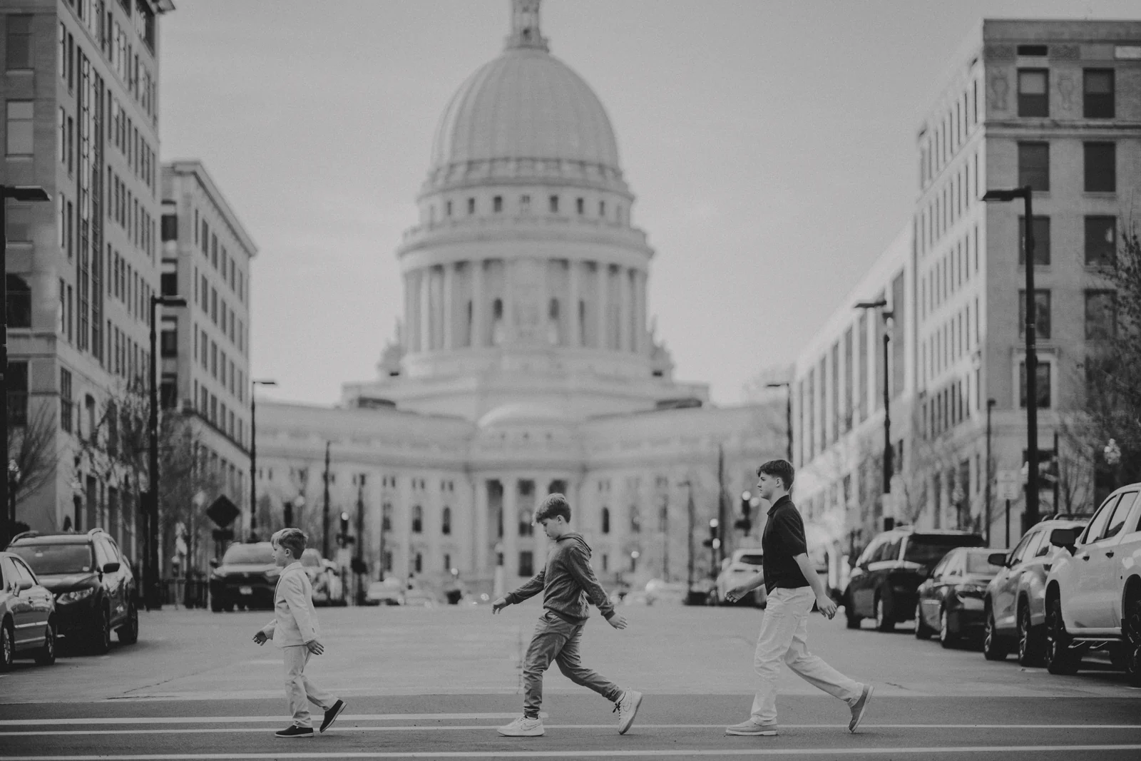 Children in the city black and white A black and white photograph of children moving across a city street near the Wisconsin Capitol.