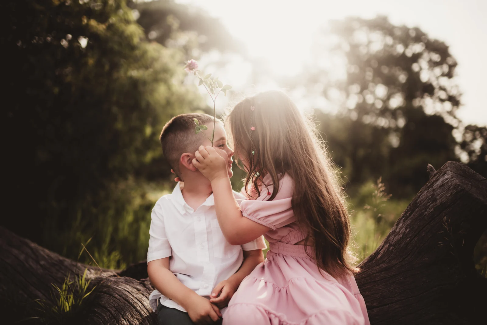 Children sharing a kiss Two young children sharing a kiss in warm evening light.