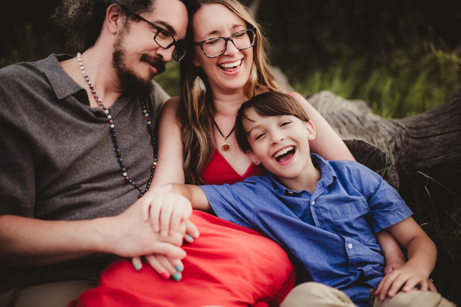 Family laughing close up Parents laughing together with their child in a close family portrait.
