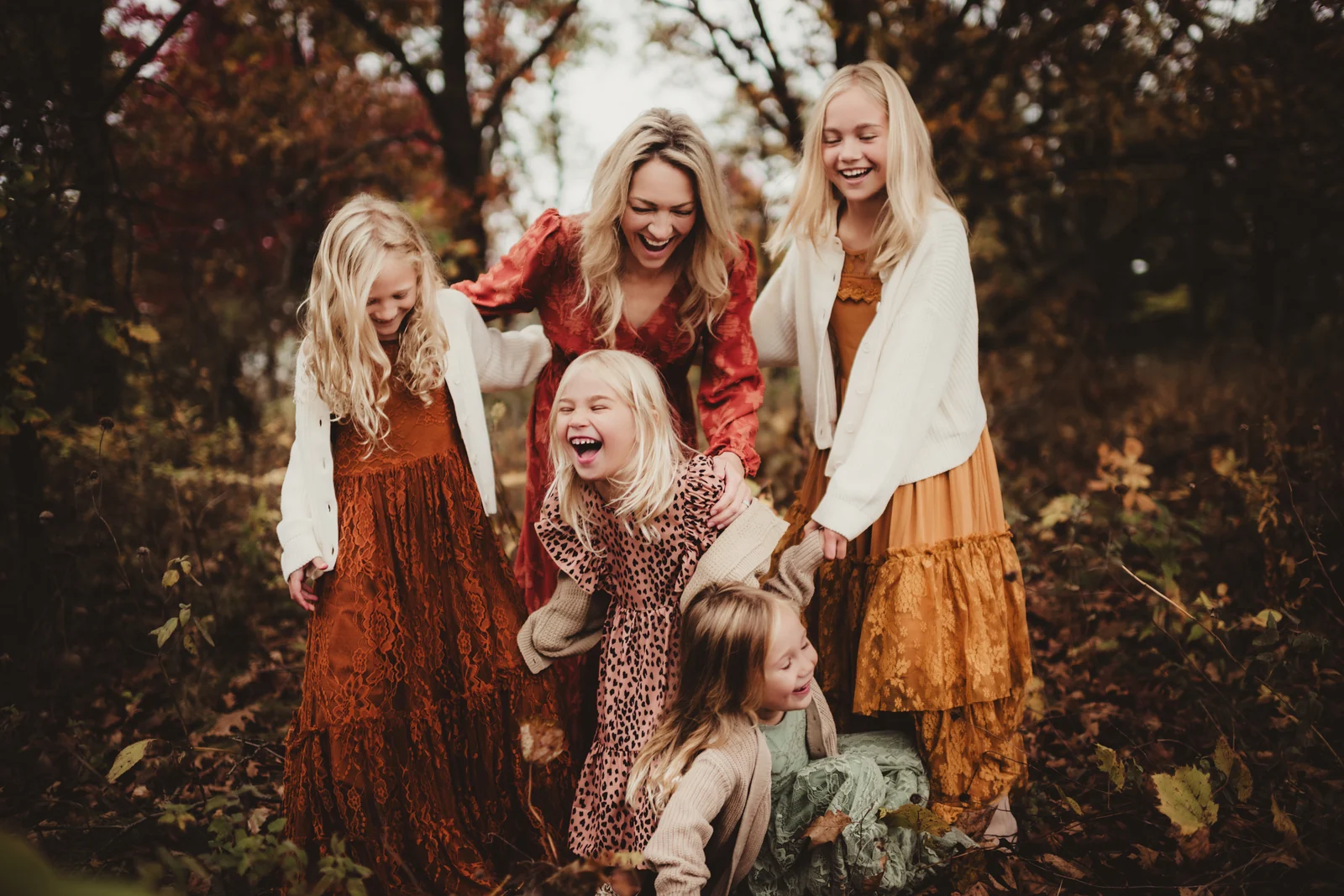 Family together in autumn Family members smiling together among colorful autumn leaves.