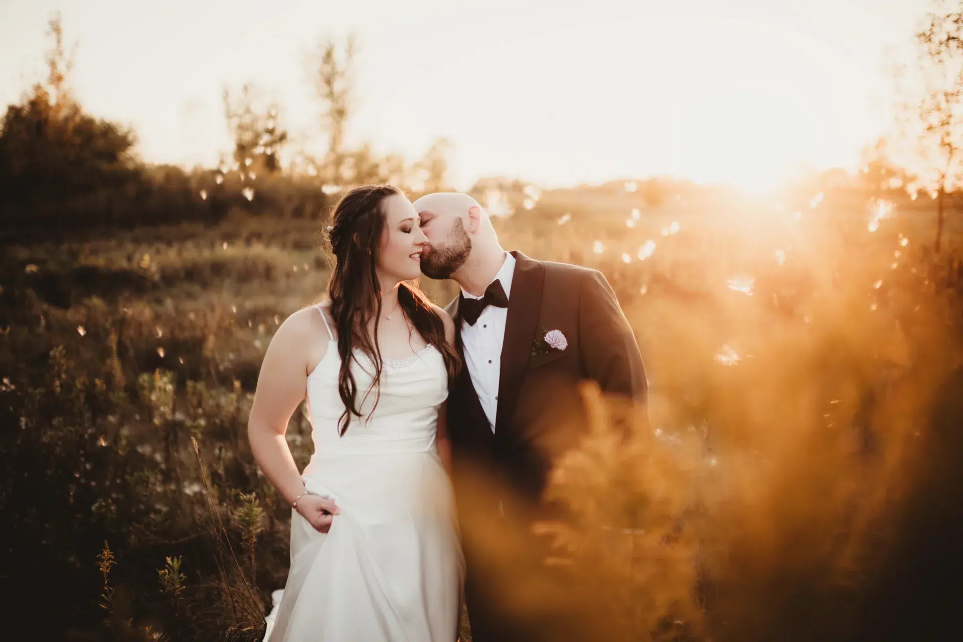 A couple sharing a kiss in warm evening light